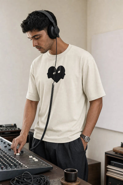 Man at a mixing console in the Alabaster Overture Oversized Tee