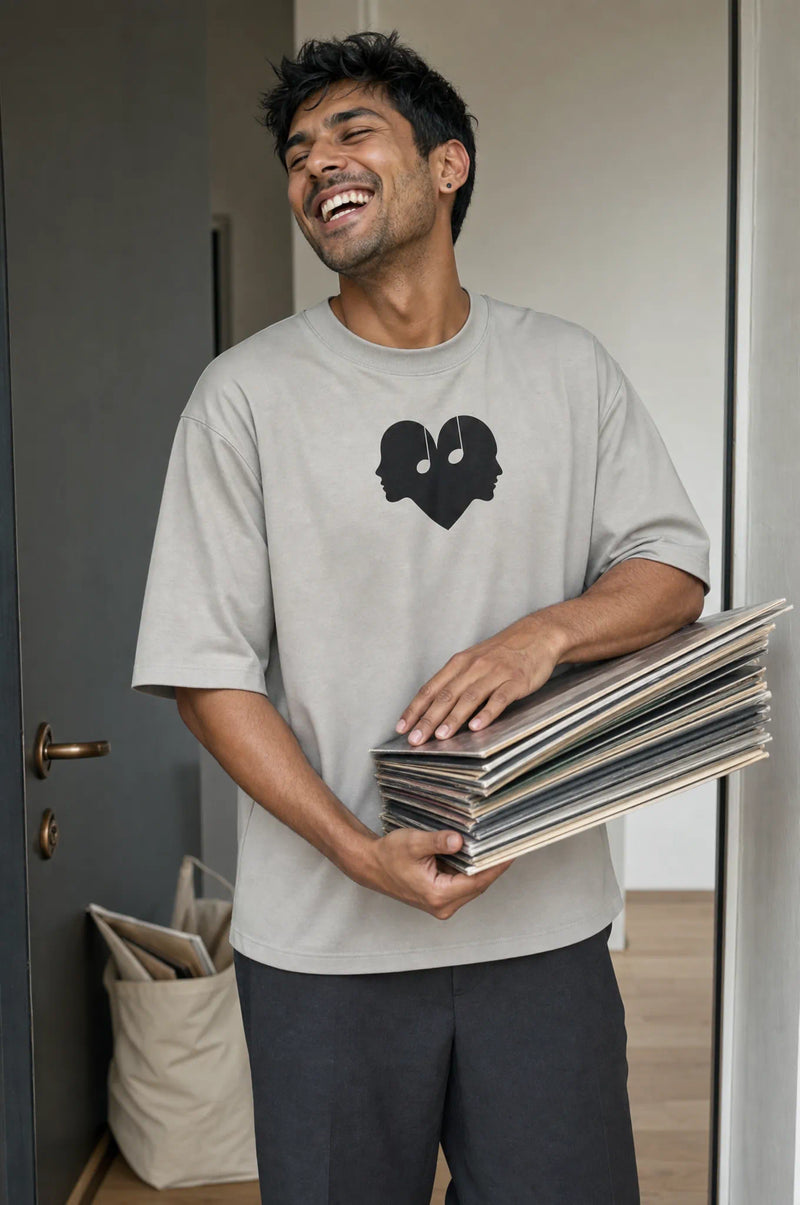 Man with vinyl records in the Ash Overture Oversized Tee