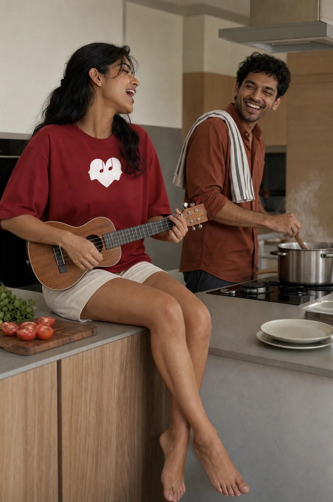 Woman playing a ukulele in the Crimson Overture Oversized Tee
