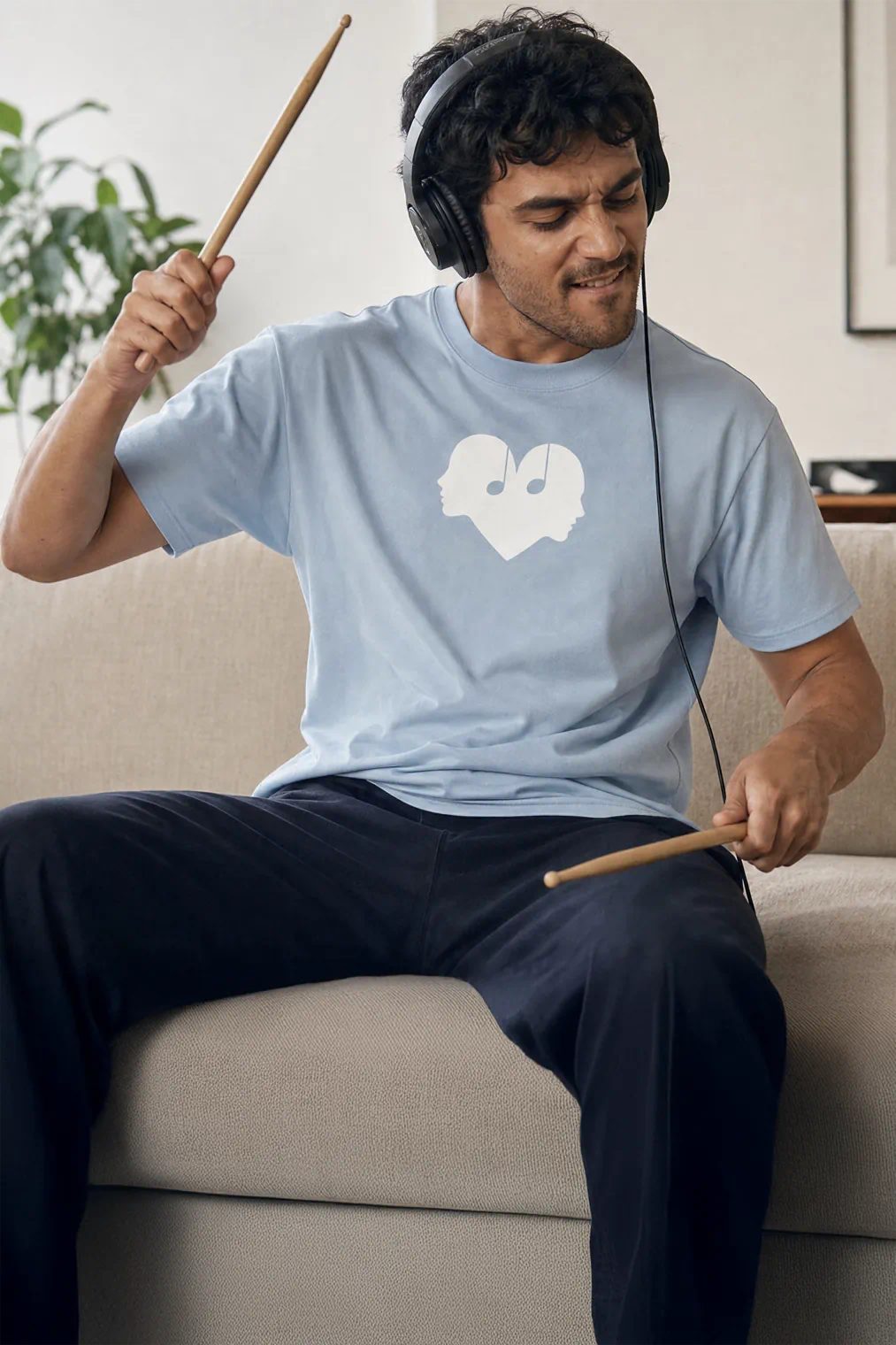 Man playing air drums in the Horizon blue Overture Oversized Tee