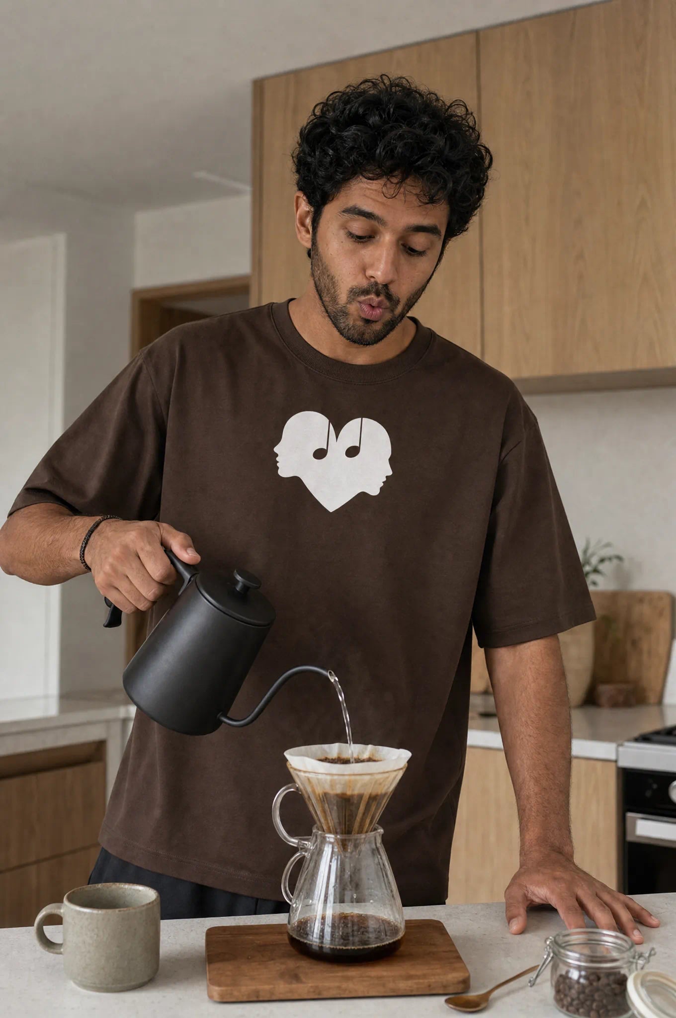 Man making coffee in the Mocha Overture Oversized Tee